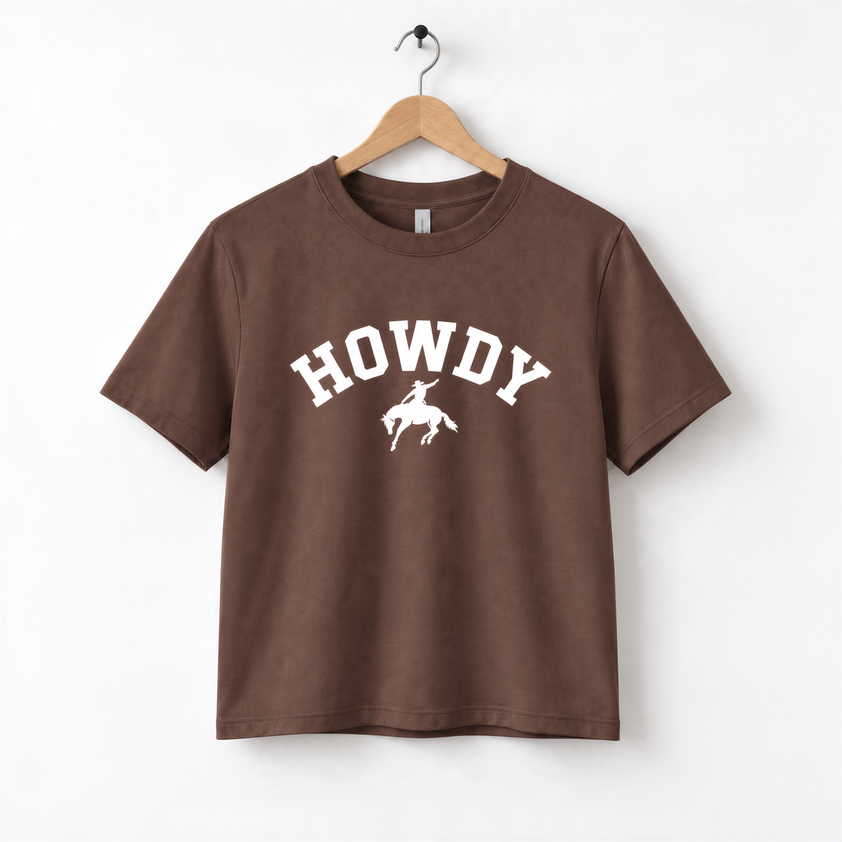 A brown t-shirt with the word "HOWDY" printed on it, along with a silhouette of a cowboy.