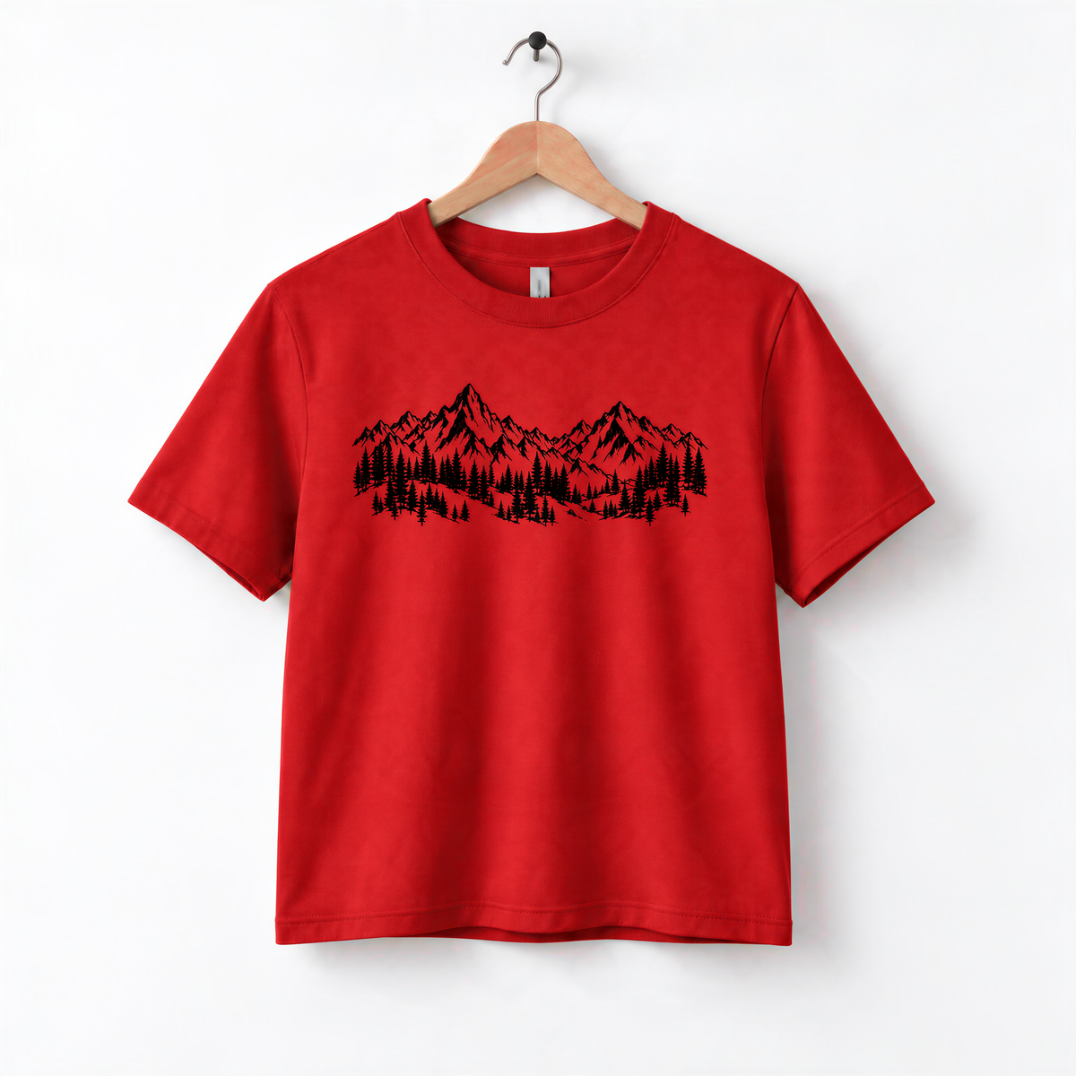 A red t-shirt with a graphic design of mountains and trees printed on it.