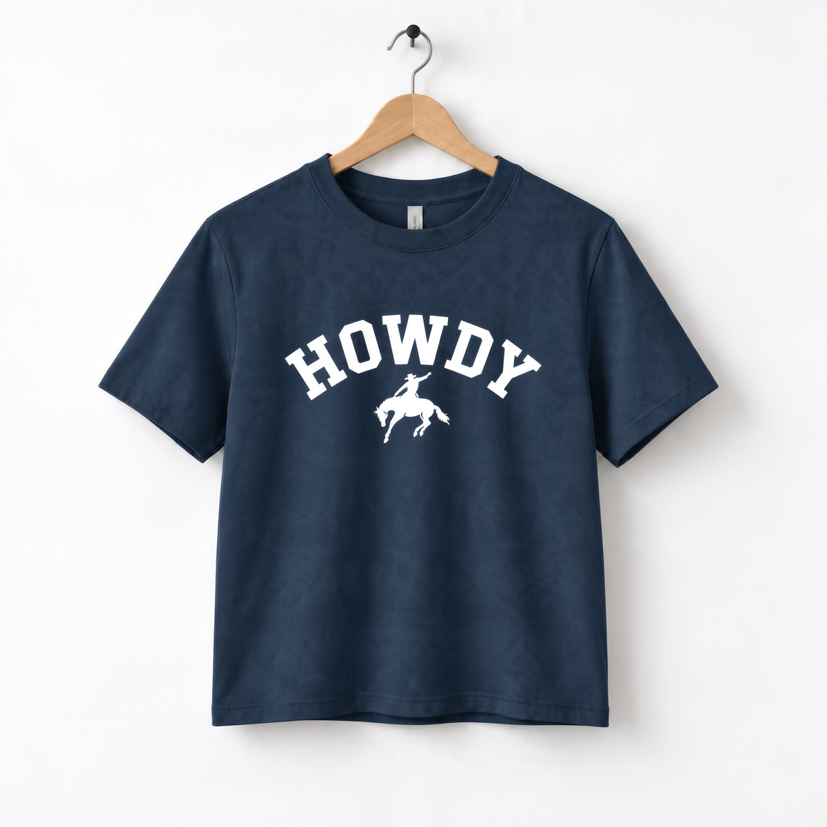 A navy blue t-shirt with the text "HOWDY" printed on it, along with a graphic of a cowboy on a bucking horse.