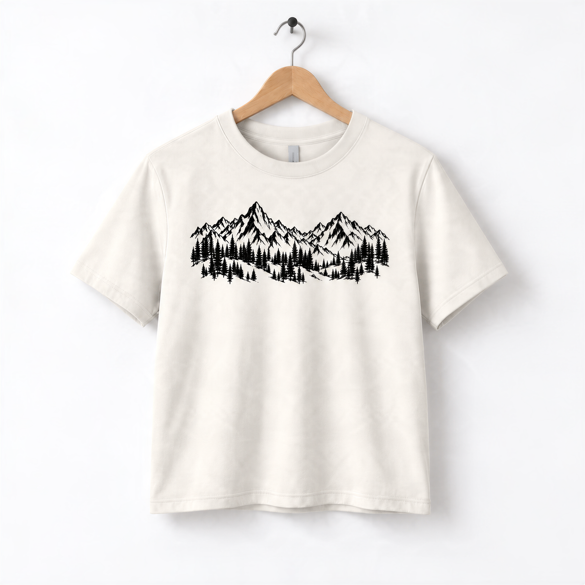 A white t-shirt with a graphic design depicting a mountain range with pine trees.