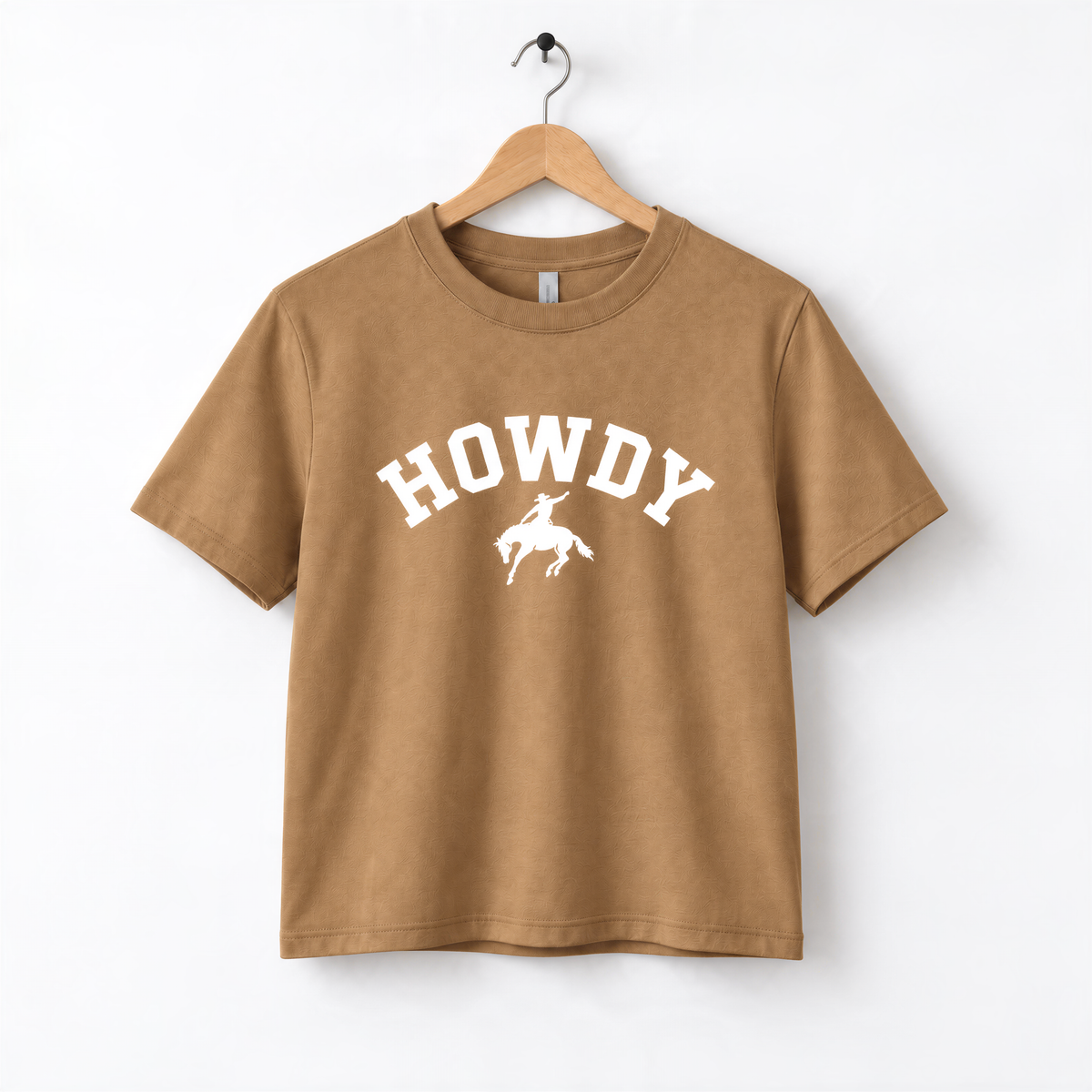 A brown t-shirt with the word "HOWDY" printed on it, along with a graphic of a cowboy.