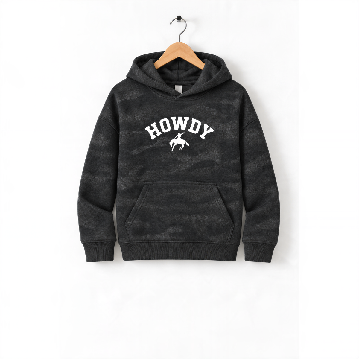 A black camouflage hoodie with the word "HOWDY" printed on it, hanging on a wooden hanger.