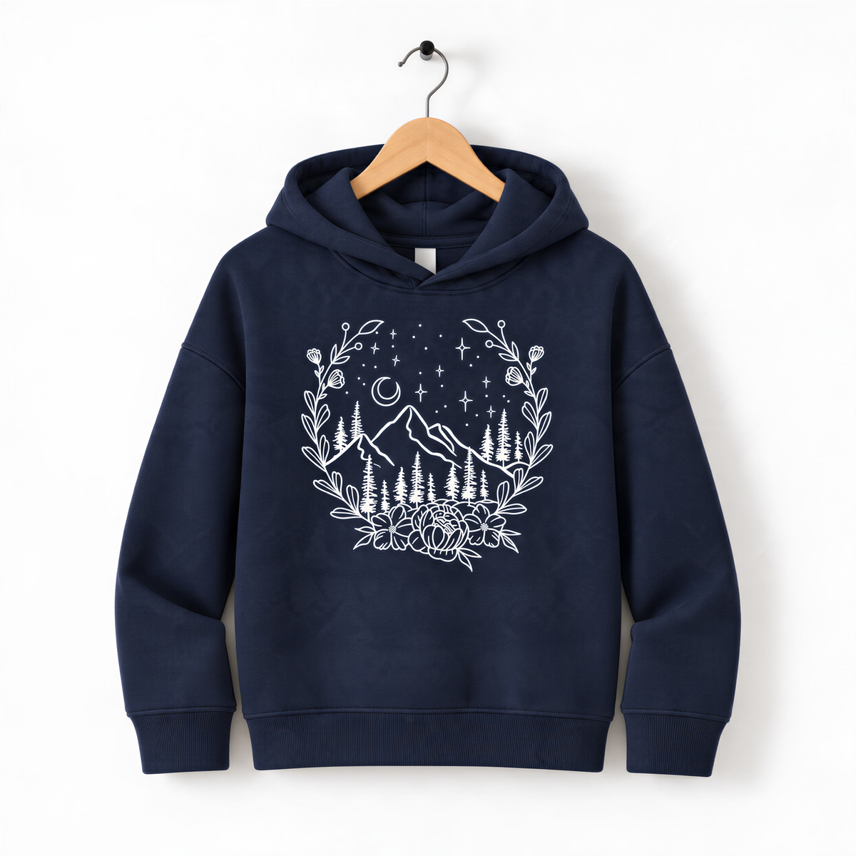 A navy blue hoodie with a white graphic design depicting a mountain landscape with trees, flowers, and stars on a wooden hanger.