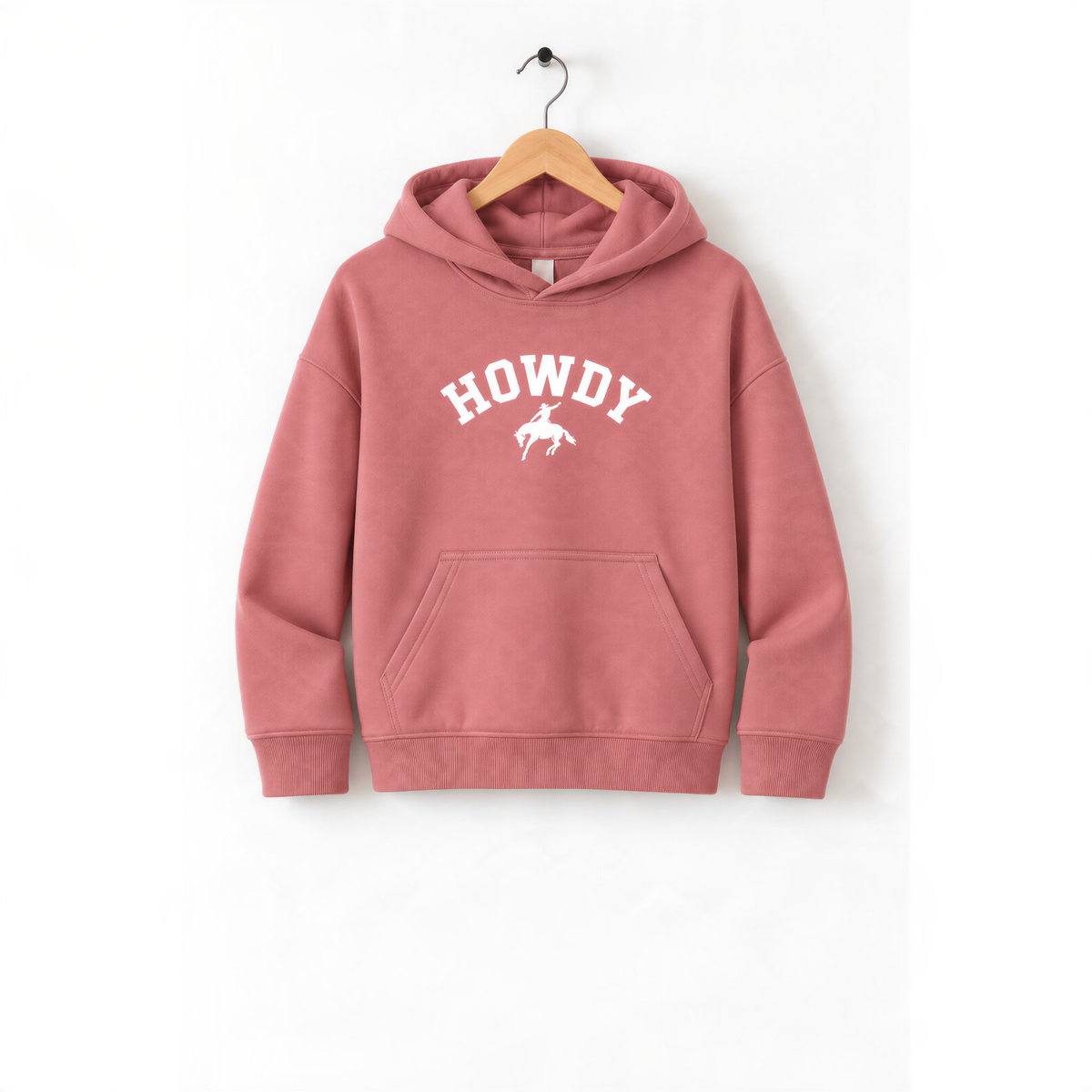 A pink hoodie with the word "HOWDY" printed on it, hanging on a wooden hanger.