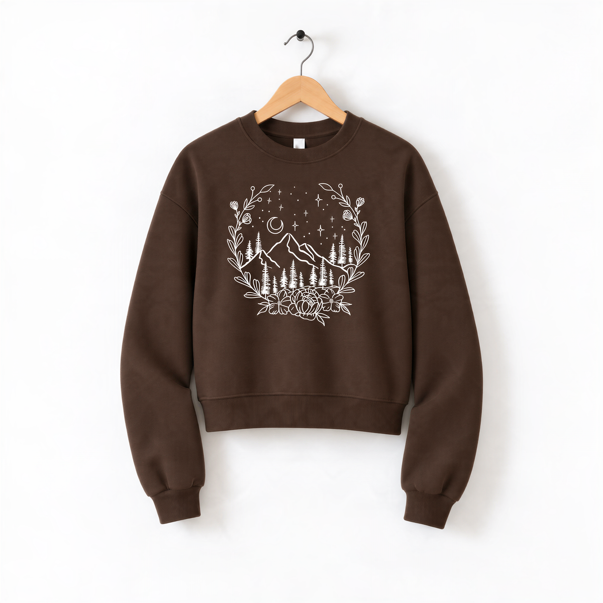 A brown sweatshirt with a white floral design on the front, hanging on a wooden hanger against a white background.