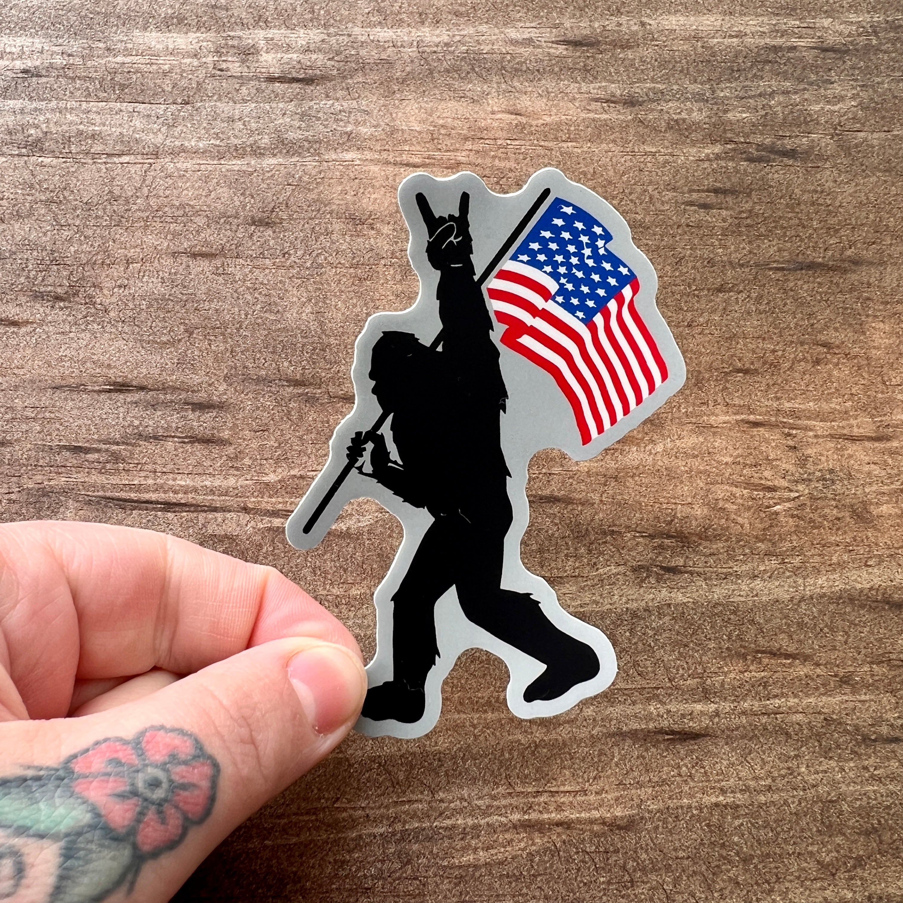 Bigfoot Carrying Flag Sticker-Sticker-208 Tees- 208 Tees, A Women's, Men's and Kids Online Graphic Tee Boutique, Located in Spirit Lake, Idaho