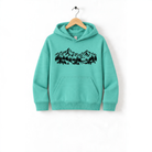 A mint green hoodie with a graphic of a mountain range and trees printed on it, hanging on a wooden hanger.