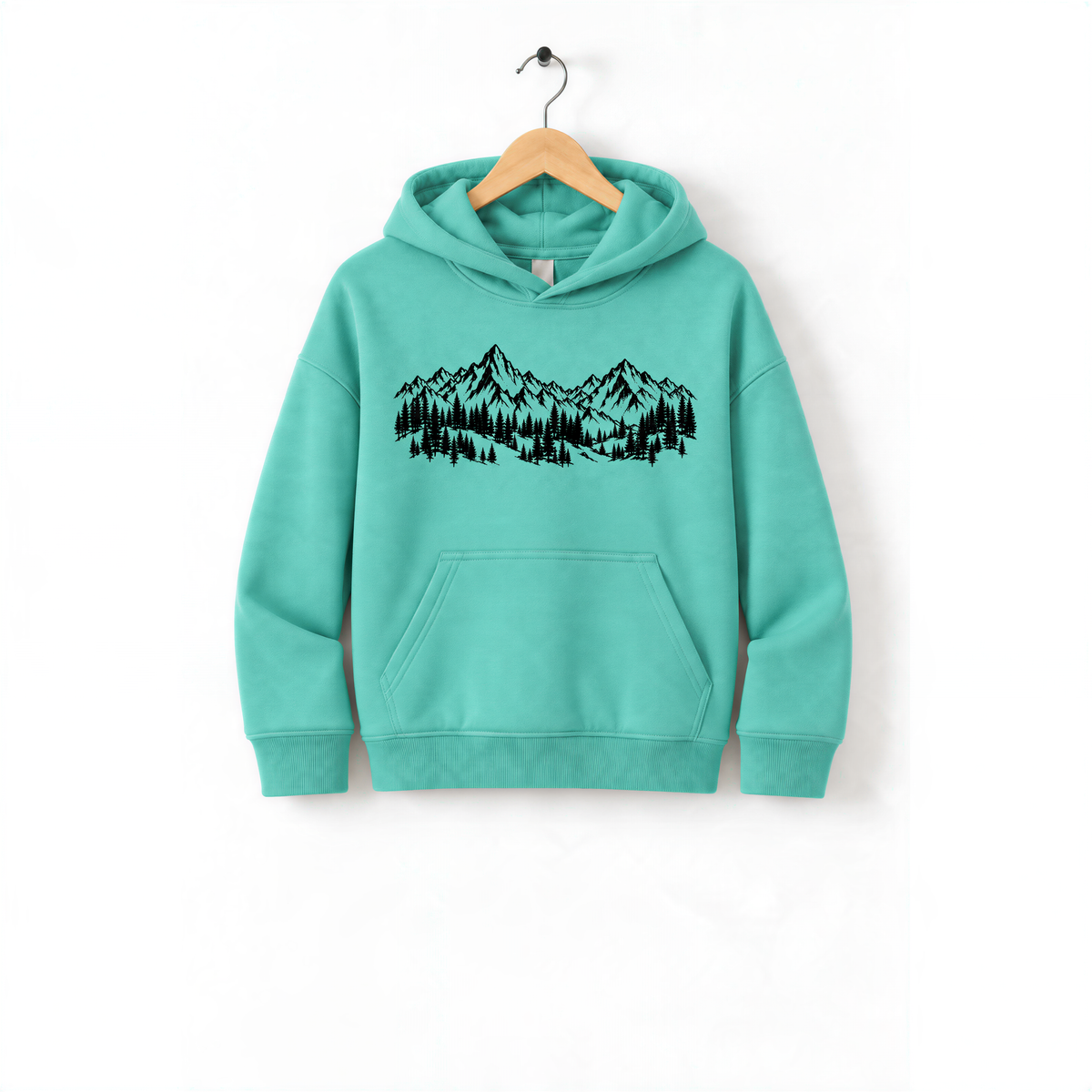 A mint green hoodie with a graphic of a mountain range and trees printed on it, hanging on a wooden hanger.
