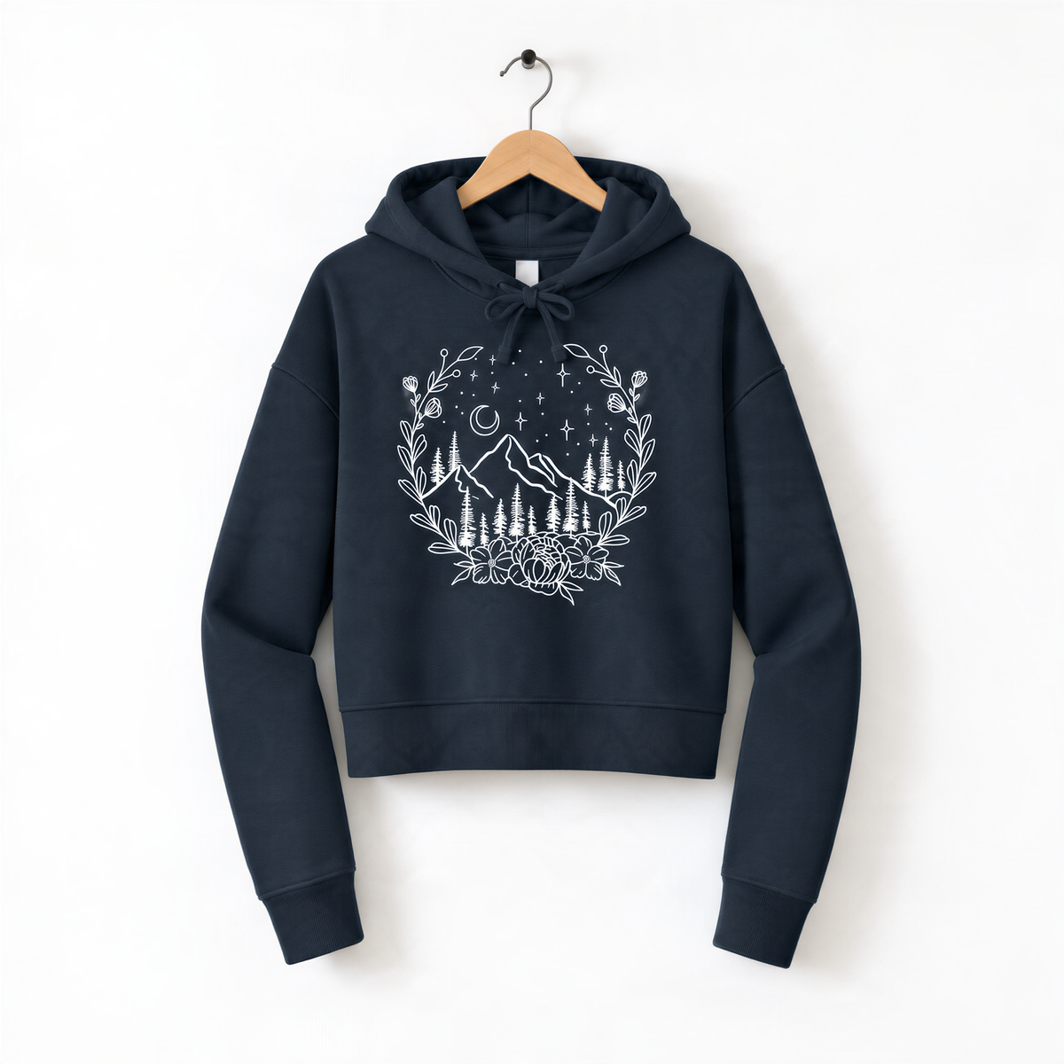 A navy blue hoodie with a white graphic design depicting a mountain landscape with trees, flowers, and stars on a dark background.