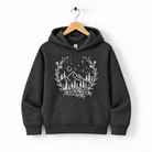 A gray hoodie with a white graphic design depicting a mountain landscape with trees, flowers, and stars on a wooden hanger.