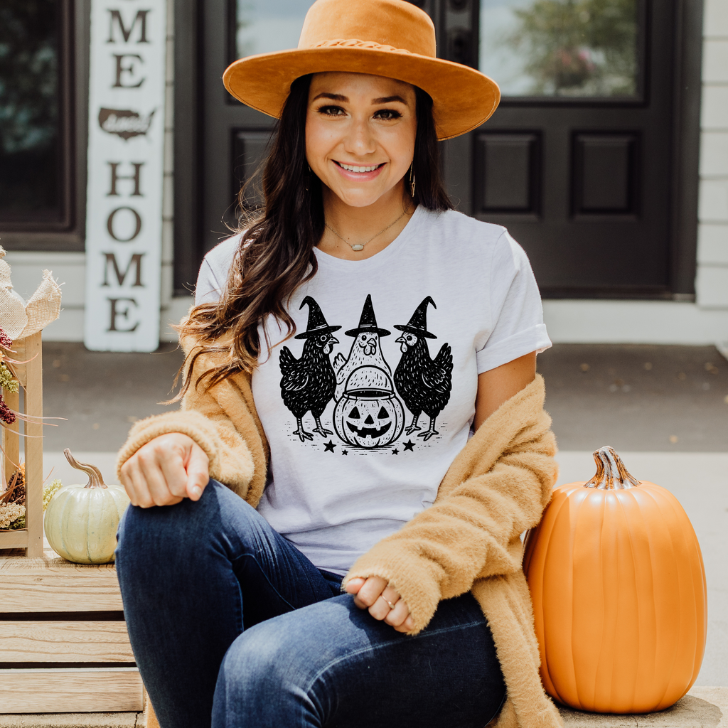 Halloween chicken shirt with three hens in witch hats around jack-o’-lantern
