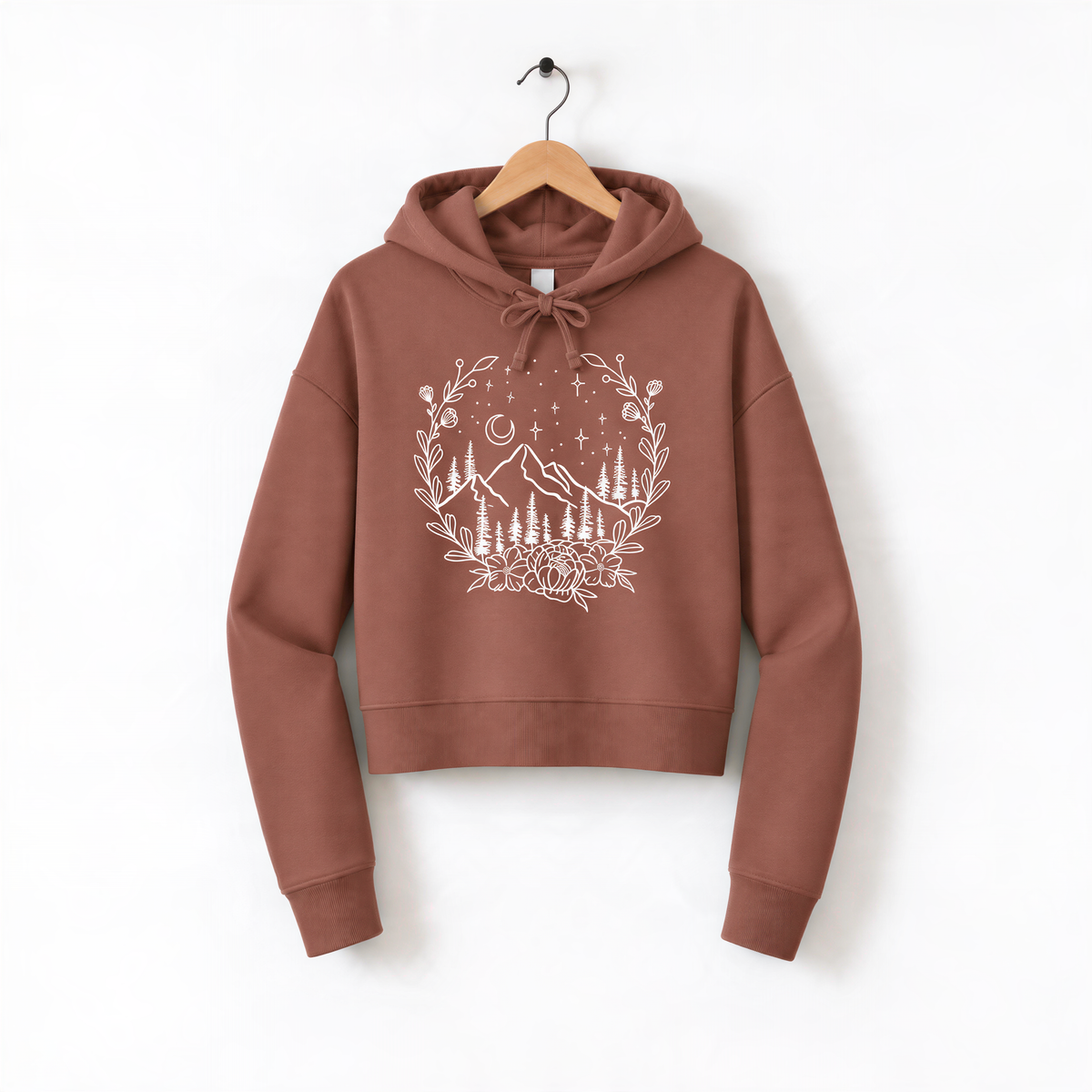 A brown hoodie with a white graphic design depicting a mountain landscape and stars on the front.