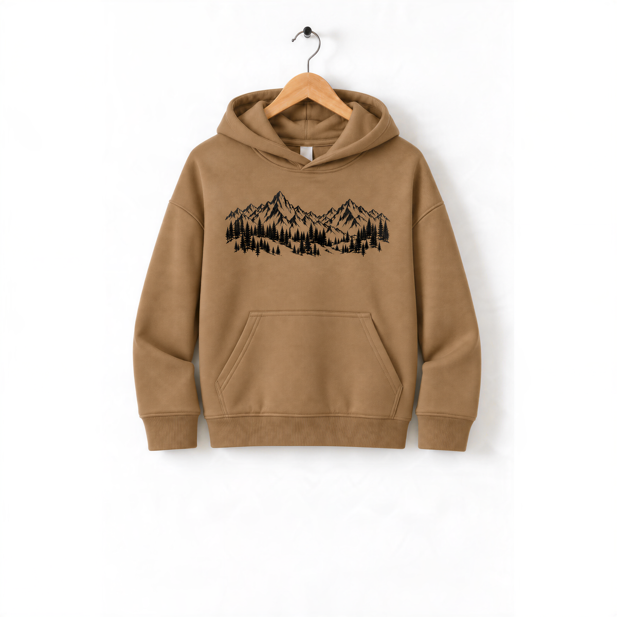A beige hoodie with a graphic of mountains and trees printed on it, hanging on a wooden hanger.