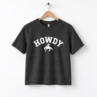 A black t-shirt with the text "HOWDY" printed on it in white letters.