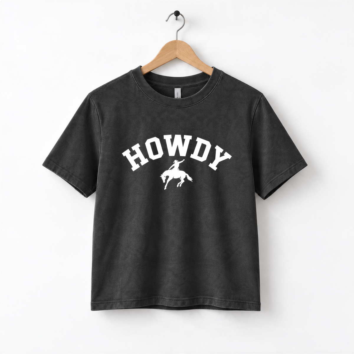 A black t-shirt with the text "HOWDY" printed on it in white letters.