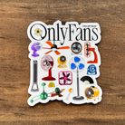 Sticker with various fan illustrations and 'OnlyFans' text on a wooden surface