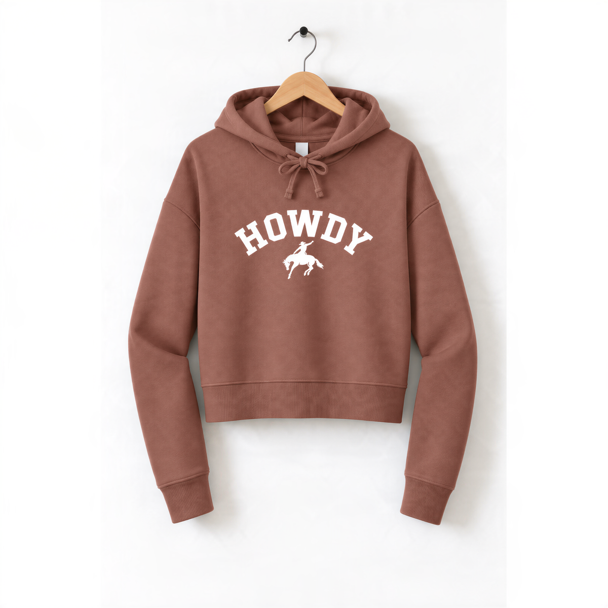 A brown hoodie with the word "HOWDY" printed on it, hanging on a wooden hanger.