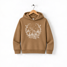 A brown hoodie with a white floral design on the front, hanging on a wooden hanger against a white background.