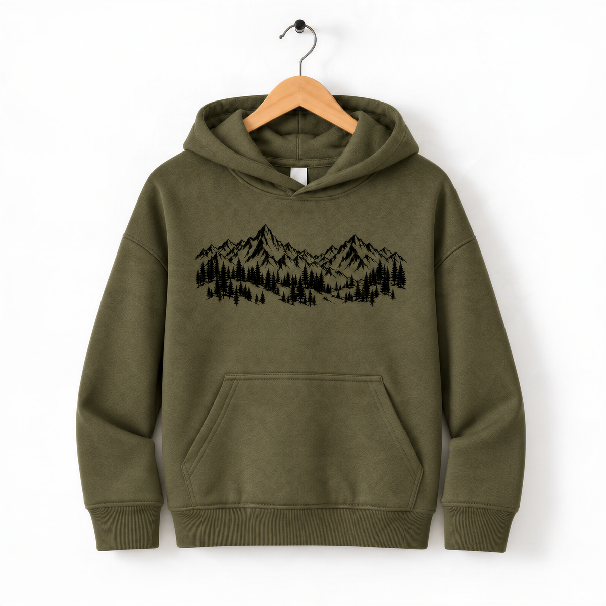 A green hoodie with a graphic of mountains and trees printed on it, hanging on a wooden hanger.