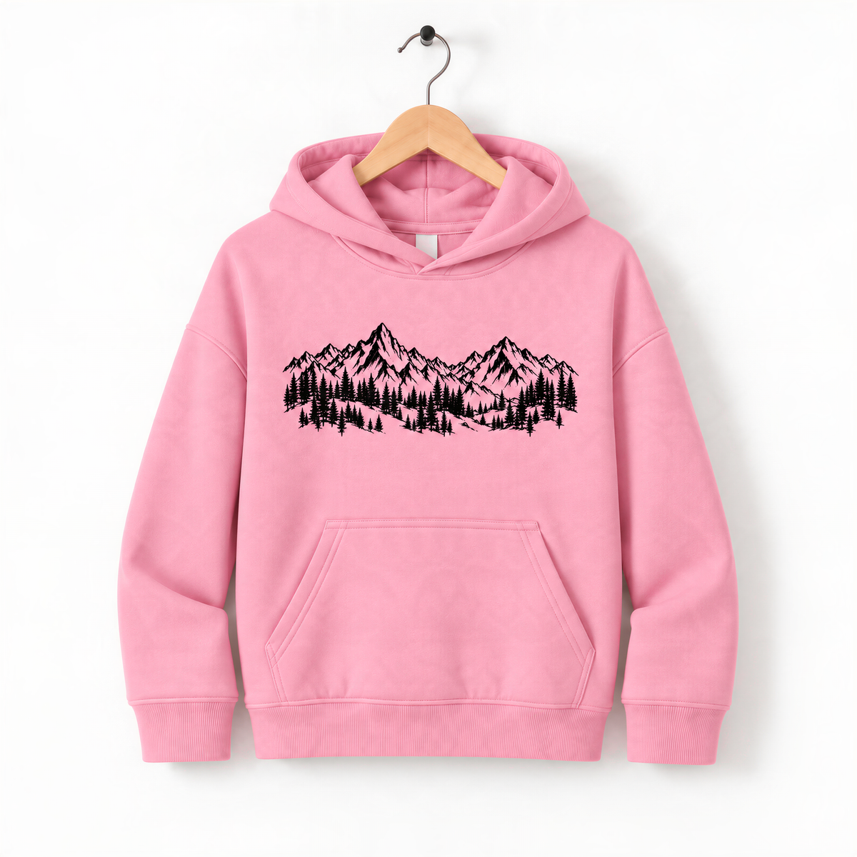 A pink hoodie with a graphic of mountains and trees printed on it, hanging on a wooden hanger.
