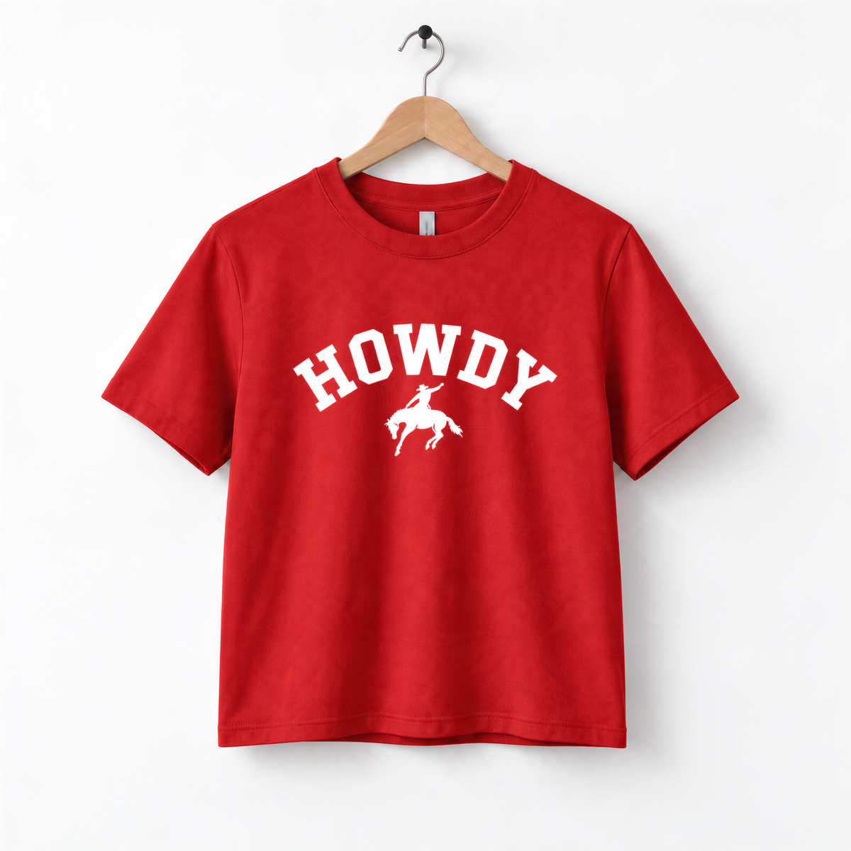 A red t-shirt with the word "HOWDY" printed on it, along with a graphic of a cowboy.