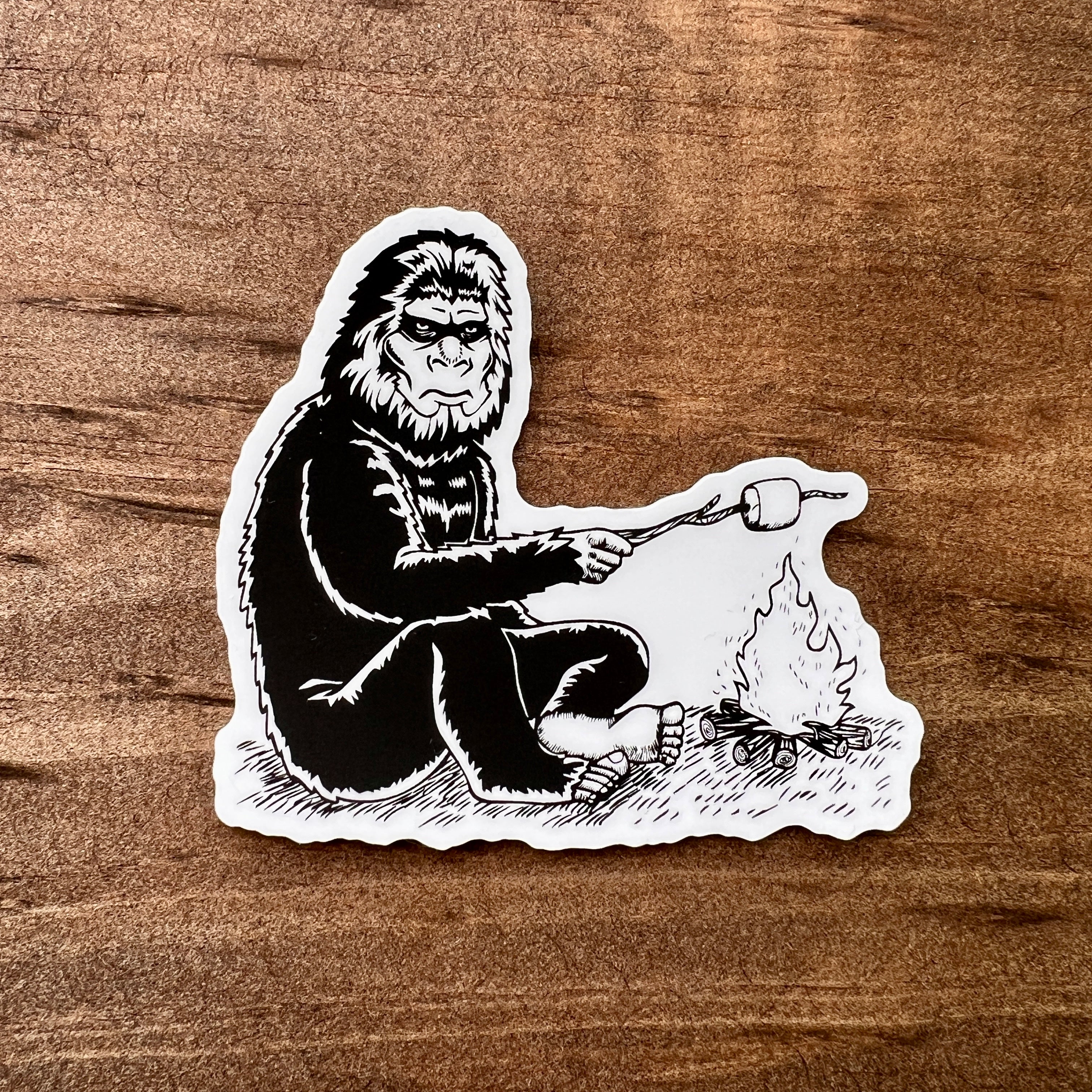 Bigfoot Roasting Marshmallow Sticker-Sticker-208 Tees- 208 Tees, A Women's, Men's and Kids Online Graphic Tee Boutique, Located in Spirit Lake, Idaho